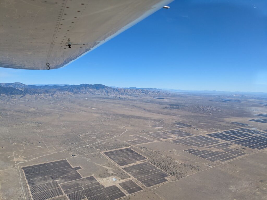 Solar panels with mountains in the background